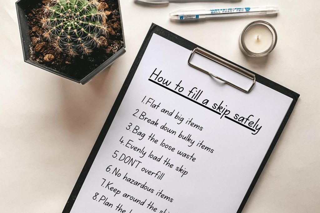 A clipboard and paper where someone has titled it how to fill a skip safely and then bullet pointed the tips